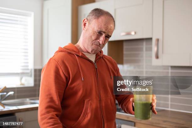 tasting healthy green vegetable juice - offense stock pictures, royalty-free photos & images