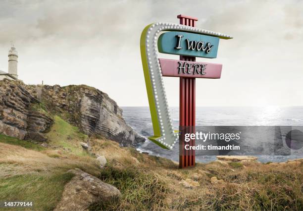 neon in the cliff with lighthouse - neon arrow stock pictures, royalty-free photos & images