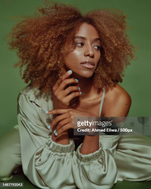 young woman with curly hair - editorial style stock pictures, royalty-free photos & images