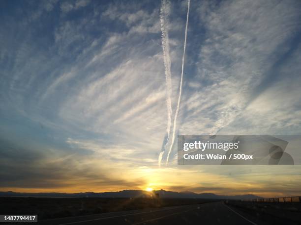 scenic view of vapor trails in sky during sunset,united states,usa - sunset with jet contrails stock pictures, royalty-free photos & images