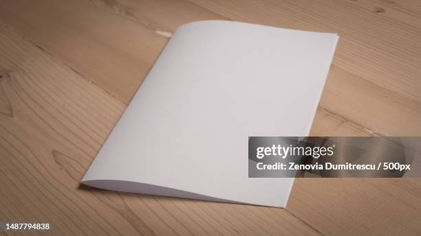 white blank paper notepad on wooden table,romania - magazine table stock pictures, royalty-free photos & images