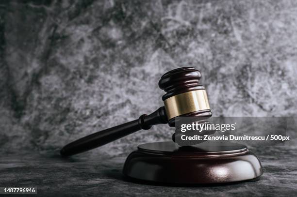 wooden judges gavel on table in a courtroom or enforcement office,romania - lawsuit stock-fotos und bilder