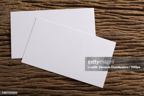 blank white business card presentation of corporate identity on wood background,romania - business cards on table stock pictures, royalty-free photos & images