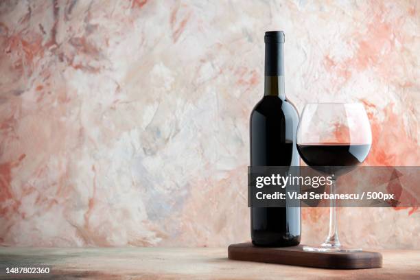 front view glass of wine with bottle and chocolate on light background alcohol bar champagne juice drink lemonade - vino fotografías e imágenes de stock