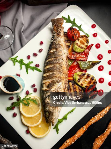 top view grilled trout with eggplant zucchini bell pepper and pomegranate sauce - trout stock pictures, royalty-free photos & images