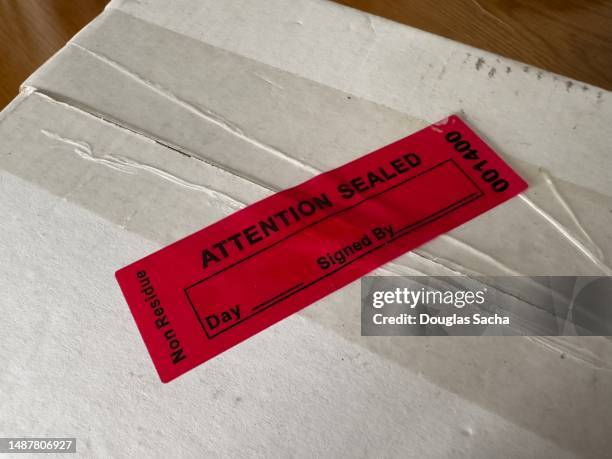 tamper proof label sealing a package - tamper proof stock pictures, royalty-free photos & images