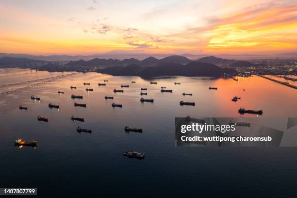 aerial view of the lines of cargo container ships waiting to enter the port - voor anker gaan stockfoto's en -beelden