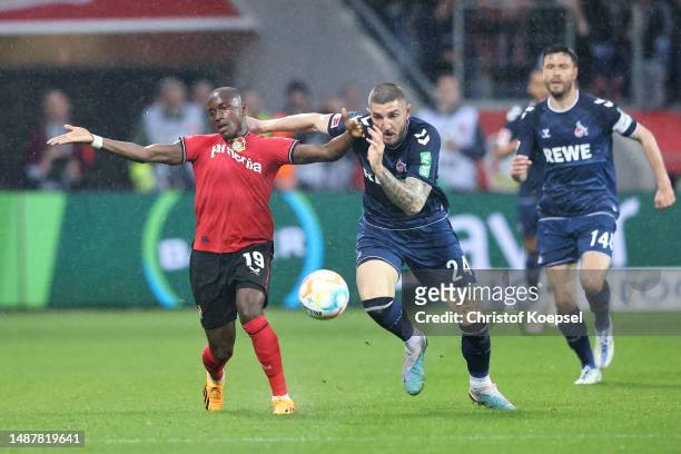 Moussa Diaby of Bayer 04 Leverkusen is challenged by Julian Chabot of 1.FC Koeln during the Bundesliga match between Bayer 04 Leverkusen and 1. FC...