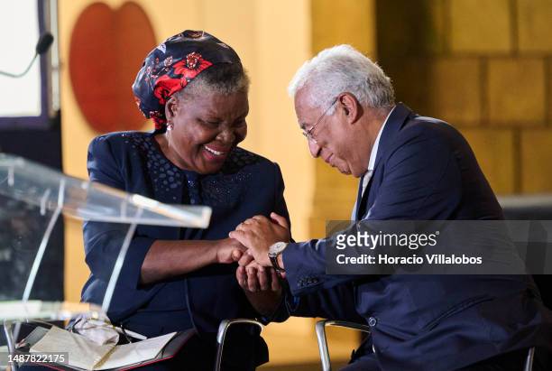 Mozambican author of novels and short stories in the Portuguese language Paulina Chiziane is congratulated onstage by Portuguese Prime Minister...