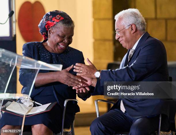 Mozambican author of novels and short stories in the Portuguese language Paulina Chiziane is congratulated onstage by Portuguese Prime Minister...