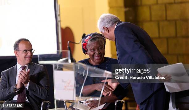 Mozambican author of novels and short stories in the Portuguese language Paulina Chiziane is congratulated onstage by Portuguese Prime Minister...