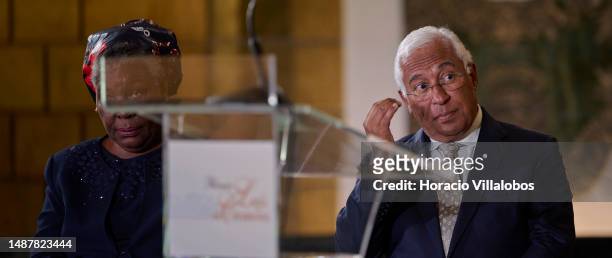 Mozambican Paulina Chiziane, author of novels and short stories in the Portuguese language, and Portuguese Prime Minister Antonio Costa sit onstage...