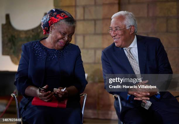 Mozambican Paulina Chiziane, author of novels and short stories in the Portuguese language, and Portuguese Prime Minister Antonio Costa laugh while...