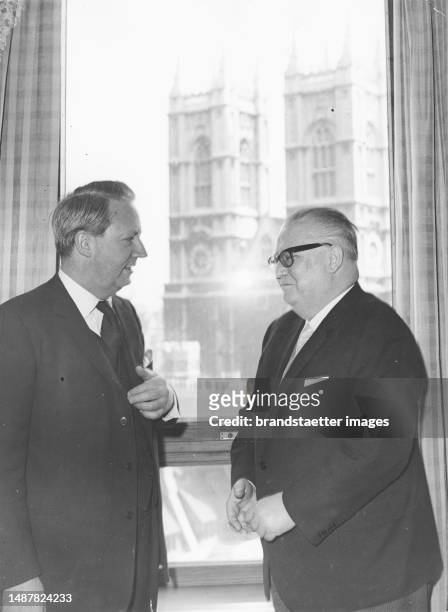 Austrian Vice Chancellor Bruno Pittermann in London. In conversation with Edward Heath . Westminster Abbey in the background. 1964.