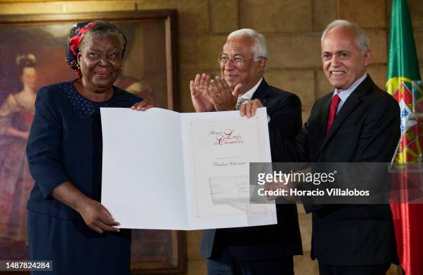 Mozambican author of novels and short stories in the Portuguese language Paulina Chiziane holds the prize diploma with Brazilian Ambassador Raimundo...