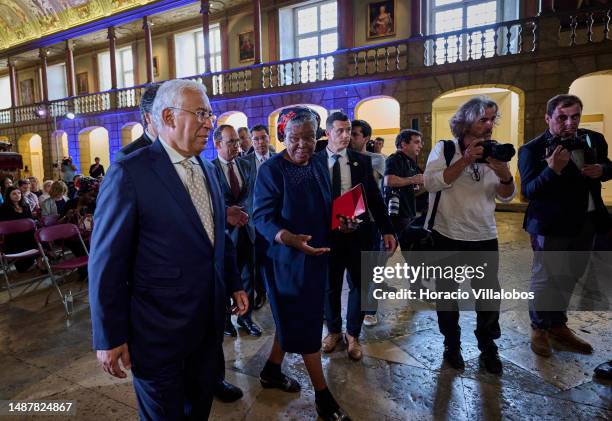 Mozambican Paulina Chiziane, author of novels and short stories in the Portuguese language, and Portuguese Prime Minister Antonio Costa walk onstage...