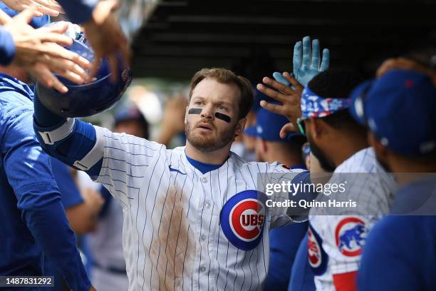 Ian Happ of the Chicago Cubs celebrates in the dugout with teammates after his two run home run in the fifth inning against the Miami Marlins at...