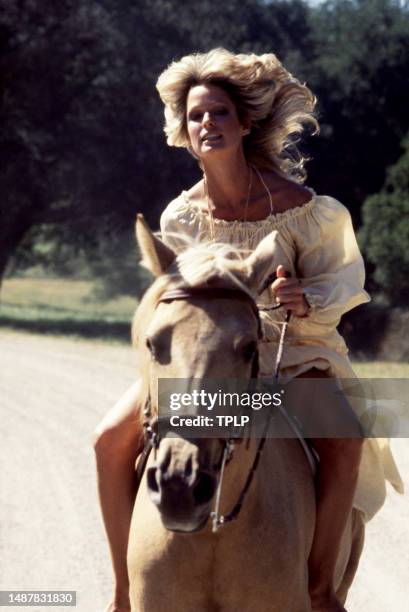 American actress Farrah Fawcett rides her horse during the Faberge commercial shoot in Los Angeles, California, circa 1977.