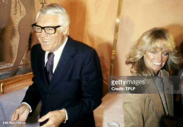 American actor Cary Grant and American actress Farrah Fawcett smile after meeting with Faberge executives about her shampoo products during the...