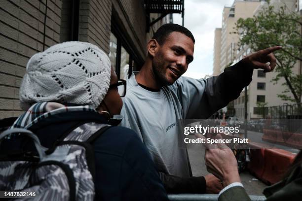 Giovanny, from Venezuela, stands outside of a former police academy building, which police have blocked from media, housing newly arrived migrants as...