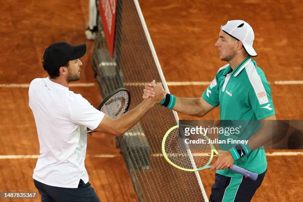 Aslan Karatsev shakes hands with Jan-Lennard Struff of Germany after the Men's Singles Semi-Final match on Day Twelve of the Mutua Madrid Open at La...