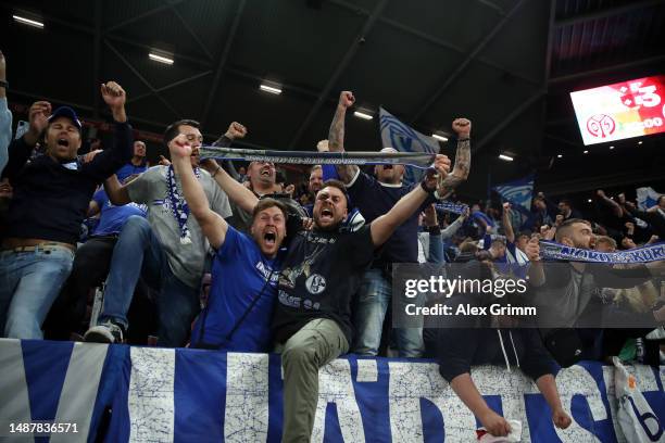 The fans of Schalke celebrate victory after the Bundesliga match between 1. FSV Mainz 05 and FC Schalke 04 at MEWA Arena on May 05, 2023 in Mainz,...