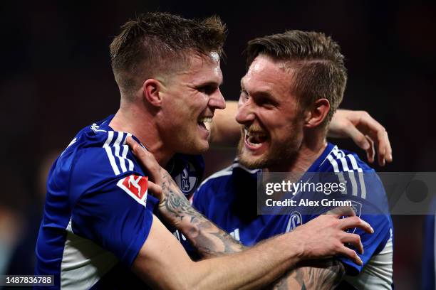 Marius Bulter and Sebastian Polter of Schalke celebrate victory after the Bundesliga match between 1. FSV Mainz 05 and FC Schalke 04 at MEWA Arena on...