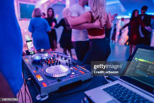 dj playing music at a party indoors - salsa stockfoto's en -beelden