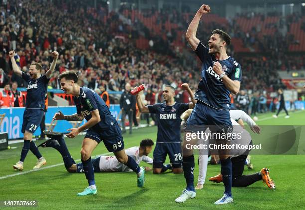 Players of 1.FC Koeln celebrate after their victory in the Bundesliga match between Bayer 04 Leverkusen and 1. FC Köln at BayArena on May 05, 2023 in...