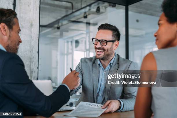 business people signing a contract in the office. - couple signing stock pictures, royalty-free photos & images