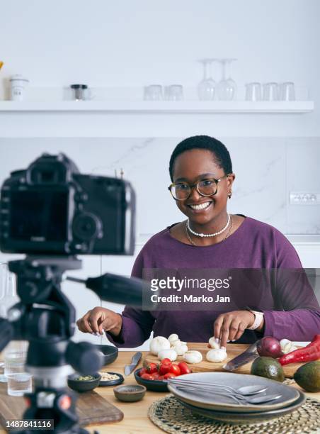 cheerful young girl making a food blogging video - schepping stockfoto's en -beelden