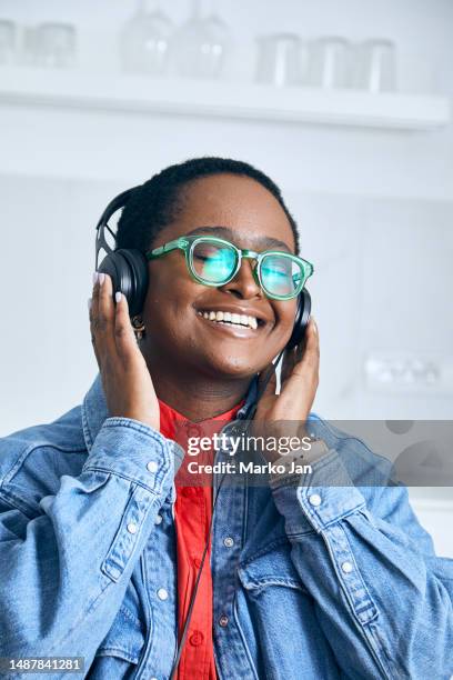 a girl with headphones, enjoying music from the smart phone - mp3 juices stock pictures, royalty-free photos & images