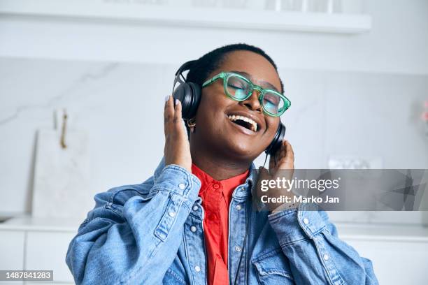 beautiful young girl with headphones, enjoying music from the smart phone - mp3 juices stock pictures, royalty-free photos & images