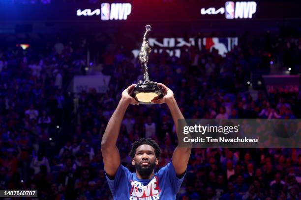 Joel Embiid of the Philadelphia 76ers hoist the MVP trophy after being named 2022-23 Kia NBA Most Valuable Player prior to game three of the Eastern...