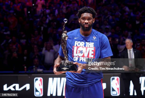 Joel Embiid of the Philadelphia 76ers poses with the MVP trophy after being named 2022-23 Kia NBA Most Valuable Player prior to game three of the...
