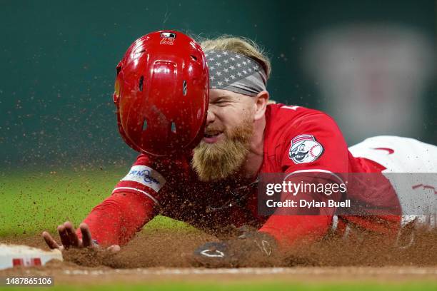 Jake Fraley of the Cincinnati Reds dives back into first while being picked off in the ninth inning against the Chicago White Sox at Great American...