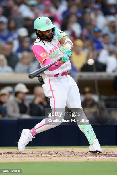 Fernando Tatis Jr. #23 of the San Diego Padres connects for a solo homerun during the third inning of a game against the Los Angeles Dodgers at PETCO...