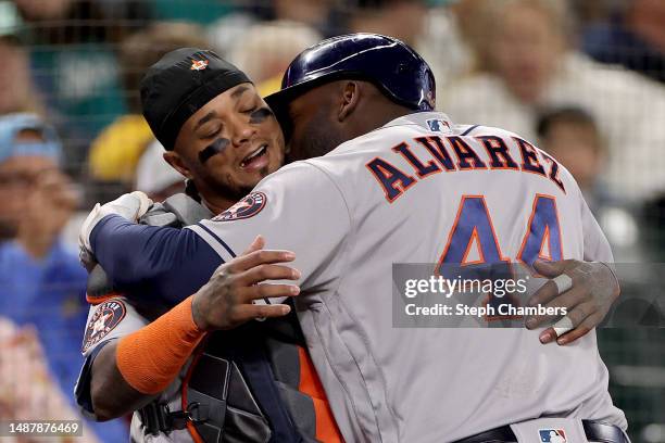 Yordan Alvarez of the Houston Astros kisses Martin Maldonado the neck after his three-run home run against the Seattle Mariners during the third...