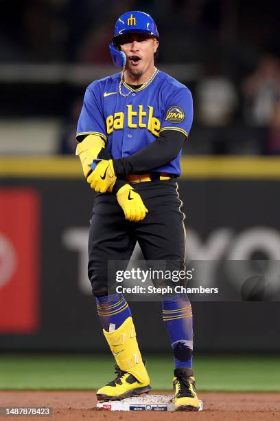 Kolten Wong of the Seattle Mariners reacts after his three-run RBI double against the Houston Astros fifth inning at T-Mobile Park on May 05, 2023 in...