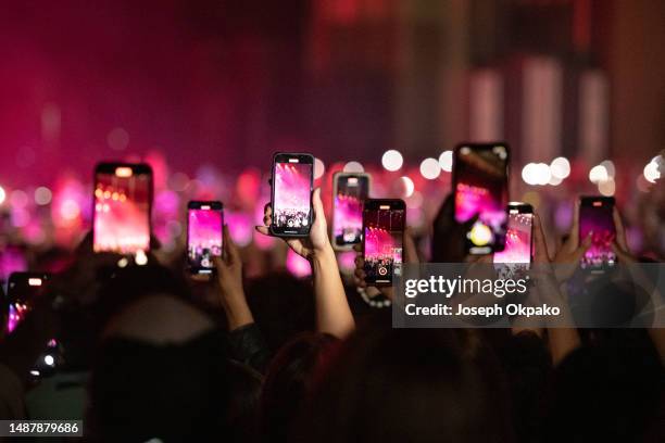 General view of music goers using their mobile phone as Giveon performs at Eventim Apollo on May 05, 2023 in London, England.