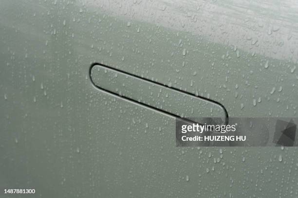 modern door handle of a car in rain - polish car stock pictures, royalty-free photos & images