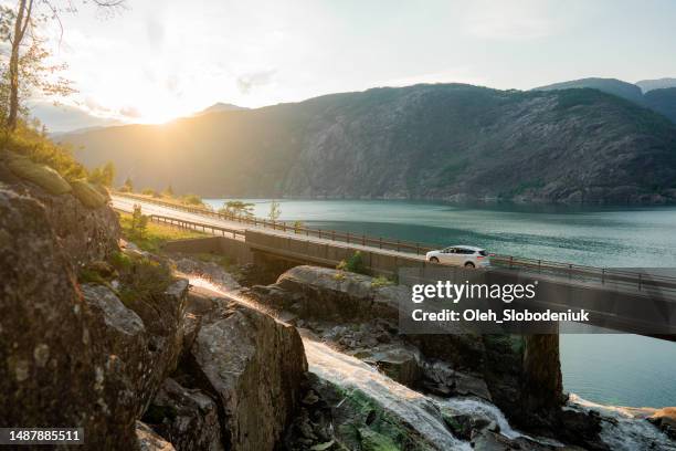 car on bridge across the river in norway - car stockfoto's en -beelden