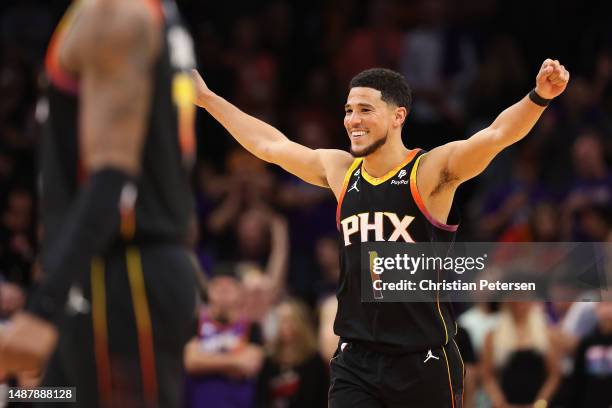 Devin Booker of the Phoenix Suns celebrates during the final moments of Game Three of the NBA Western Conference Semifinals against the Denver...