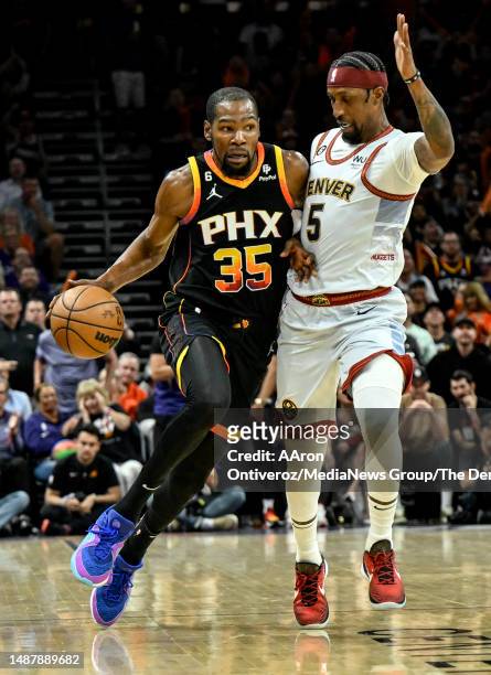 Kevin Durant of the Phoenix Suns runs in transition against Kentavious Caldwell-Pope of the Denver Nuggets before dunking during the third quarter at...