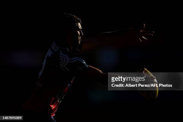 Christian Petracca of the Demons warms up ahead of the round eight AFL match between the Gold Coast Suns and the Melbourne Demons at Heritage Bank...