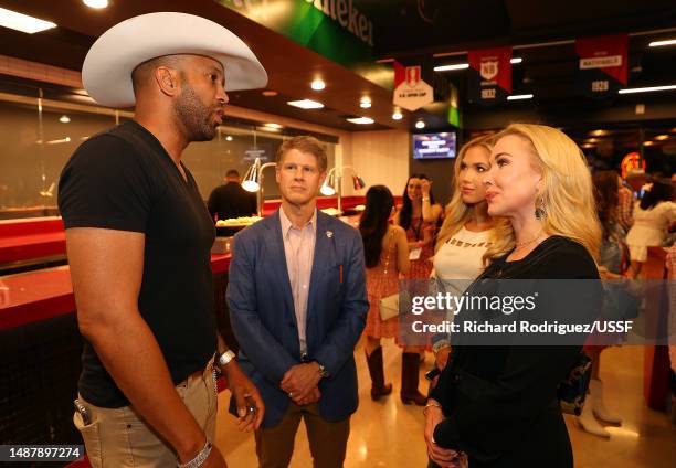 Coffey Anderson speaks with Clark Hunt, Gracie Hunt and Tavia Hunt at the the US Soccer Hall of Fame VIP Party at Toyota Stadium on May 05, 2023 in...