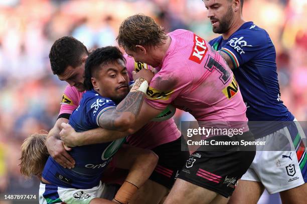 Adam Pompey of the Warriors is tackled during the round 10 NRL match between the New Zealand Warriors and Penrith Panthers at Suncorp Stadium on May...