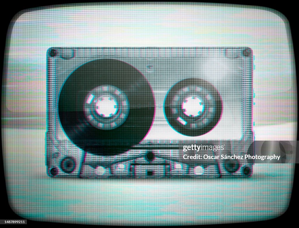 Cassette audio tape with glitch vhs effect on tube tv screen