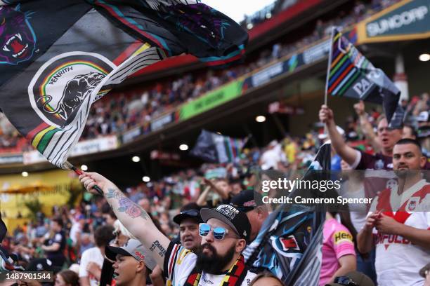 Panthers fans celebrate during the round 10 NRL match between the New Zealand Warriors and Penrith Panthers at Suncorp Stadium on May 06, 2023 in...