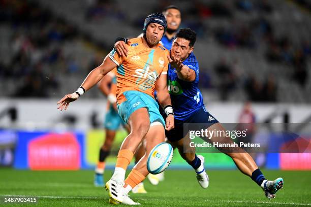 Roger Tuivasa-Sheck of the Blues tackles Christian Leali'ifano of Moana Pasifika during the round 11 Super Rugby Pacific match between the Blues and...